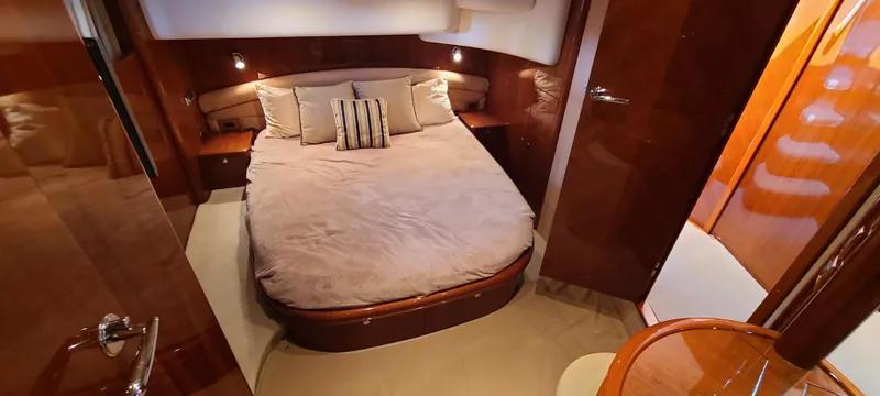 Slide: The Image of Luxurious bedroom with a large bed, wooden furnishings, and soft lighting on a yacht. - 4
