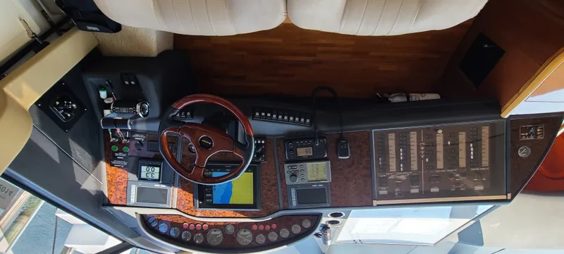 Slide: The Image of The cockpit of a 2006 Viking Princess 61 Flybridge with wood paneling and modern instruments. - 15