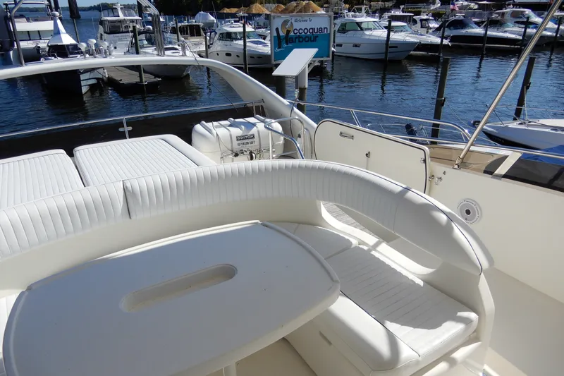 Slide: The Image of 2008 Viking Sport Cruisers 61 Motor Yacht interior with white seating at a marina. - 33