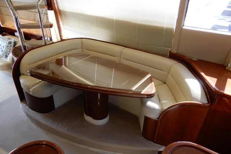 Slide: The Image of Luxurious dining area in 2008 Viking Sport Cruisers 61 Motor Yacht, featuring elegant wood and leather seating. - 66