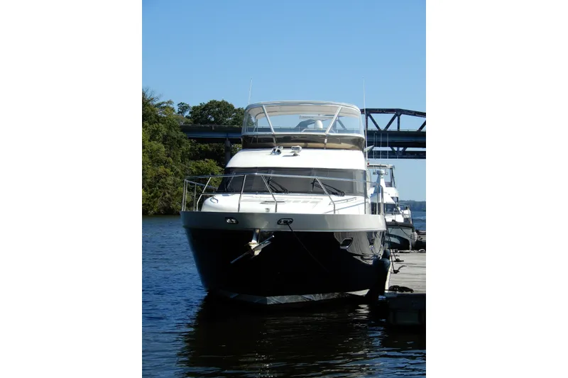 Slide: The Image of 2008 Viking Sport Cruisers 61 Motor Yacht docked on a sunny day. - 4