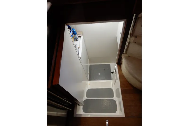 Slide: The Image of Laundry area in 2008 Viking Sport Cruisers 61 Motor Yacht with storage and cleaning supplies. - 76