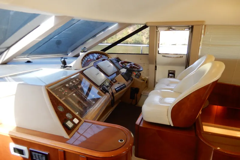 Slide: The Image of Luxurious helm of 2008 Viking Sport Cruisers 61 Motor Yacht with leather seating. - 80
