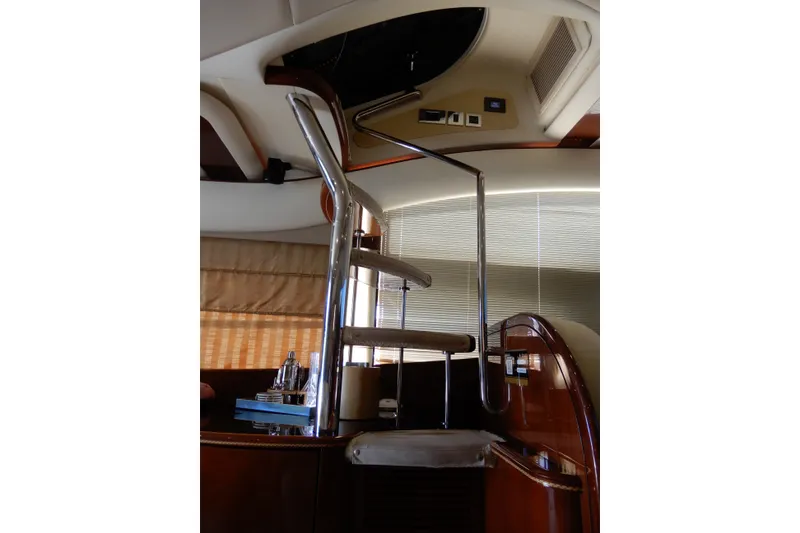 Slide: The Image of Interior spiral staircase on 2008 Viking Sport Cruisers 61 Motor Yacht, featuring sleek design. - 64
