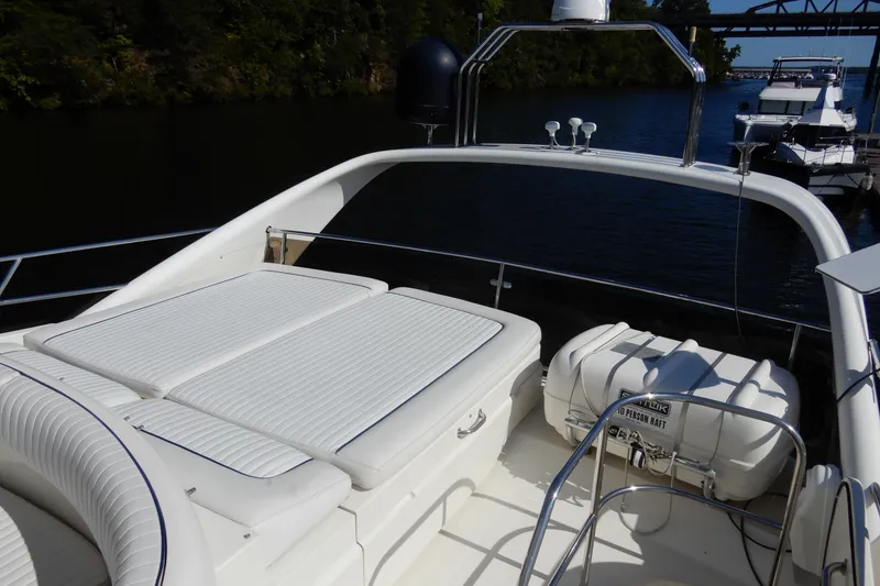 Slide: The Image of 2008 Viking Sport Cruisers 61 Motor Yacht deck with seating and life raft. - 31