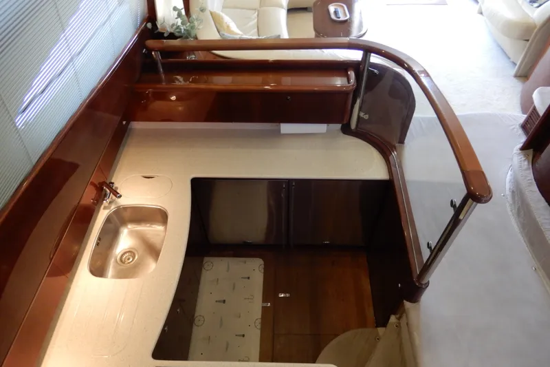 Slide: The Image of Interior view of 2008 Viking Sport Cruisers 61 Motor Yacht kitchen area with sink and cabinetry. - 69