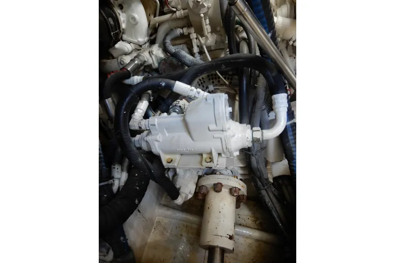 Slide: The Image of Engine compartment of a 2008 Viking Sport Cruisers 61 Motor Yacht, showing mechanical components and hoses. - 126