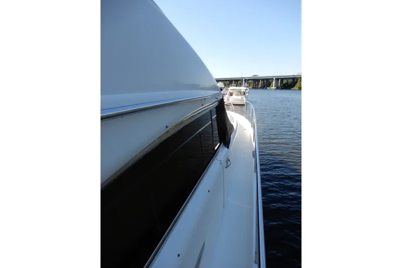 Slide: The Image of 2008 Viking Sport Cruisers 61 Motor Yacht docked on calm water. - 15