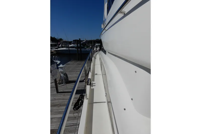 Slide: The Image of Side view of 2008 Viking Sport Cruisers 61 Motor Yacht docked at marina. - 22