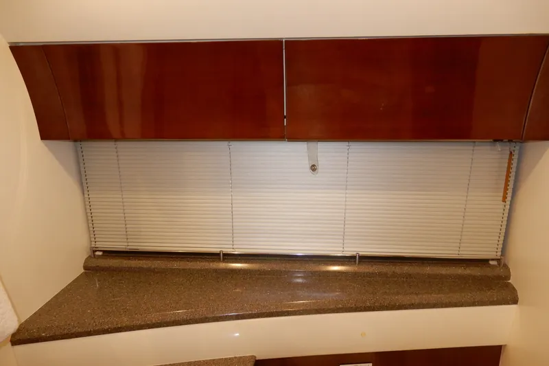 Slide: The Image of Interior of 2008 Viking Sport Cruisers 61 Motor Yacht with wooden cabinets and blinds. - 121