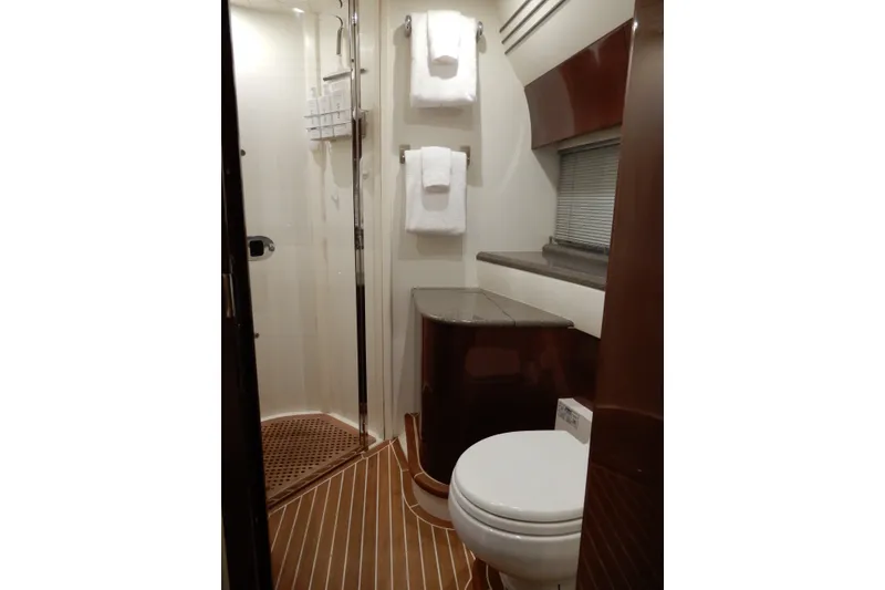 Slide: The Image of Luxurious bathroom in 2008 Viking Sport Cruisers 61 Motor Yacht, featuring shower and elegant wood finishes. - 119