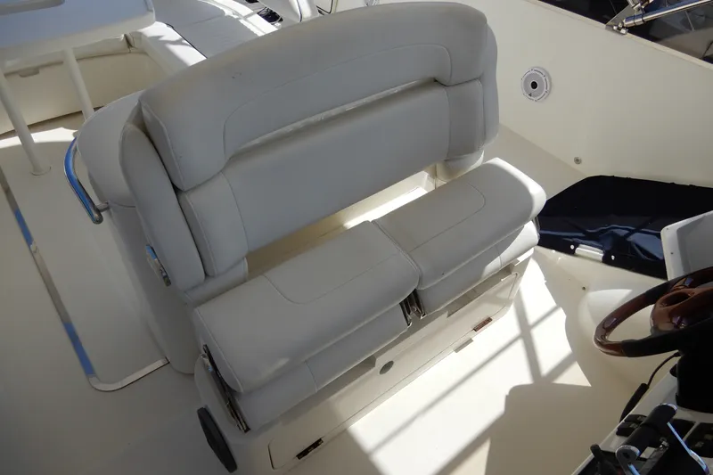 Slide: The Image of 2008 Viking Sport Cruisers 61 Motor Yacht helm seat with white upholstery. - 44