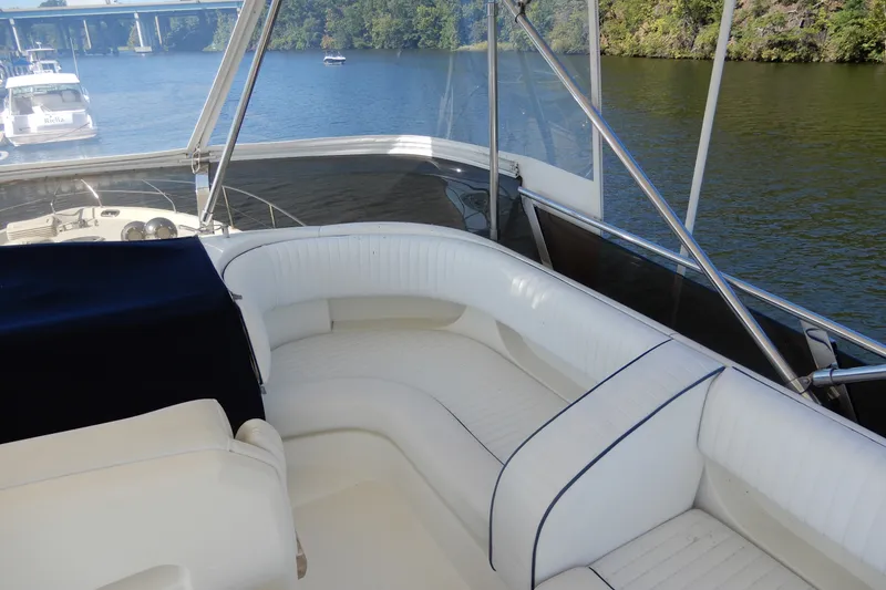 Slide: The Image of 2008 Viking Sport Cruisers 61 Motor Yacht interior with white seating, overlooking serene waterway. - 41