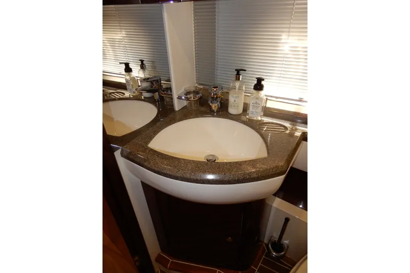 Slide: The Image of Luxurious bathroom sink on 2008 Viking Sport Cruisers 61 Motor Yacht, featuring elegant fixtures. - 96