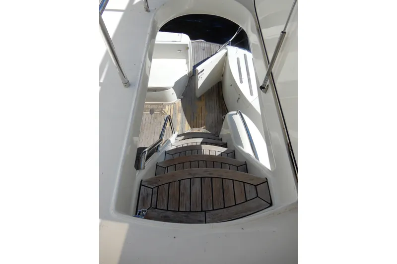 Slide: The Image of Staircase on 2008 Viking Sport Cruisers 61 Motor Yacht with wooden steps and metal railings. - 27