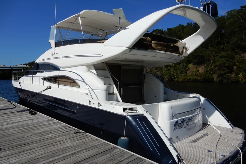 Slide: The Image of 2008 Viking Sport Cruisers 61 Motor Yacht docked on a sunny day. - 7
