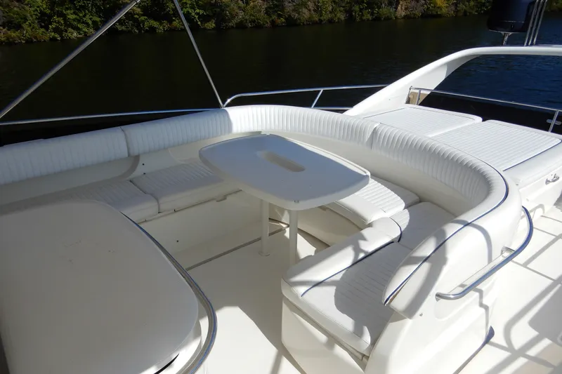 Slide: The Image of 2008 Viking Sport Cruisers 61 Motor Yacht, featuring elegant white seating and table on deck. - 30