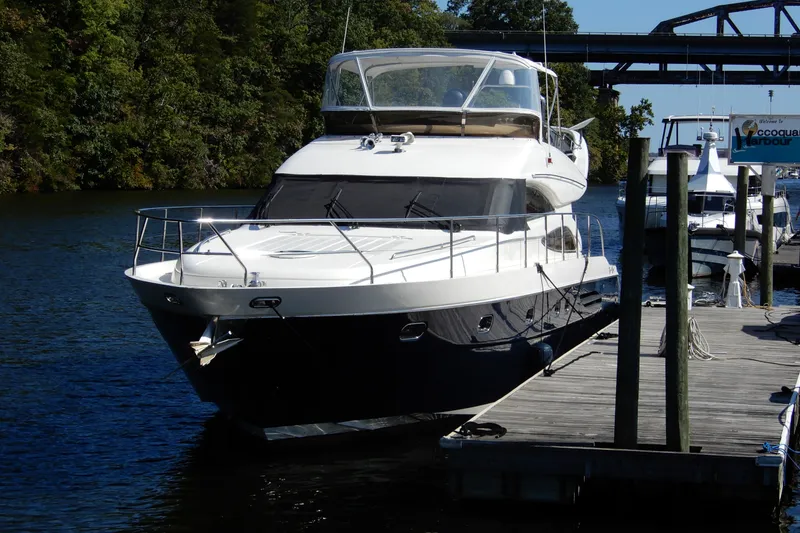 Slide: The Image of 2008 Viking Sport Cruisers 61 Motor Yacht docked at a marina. - 1