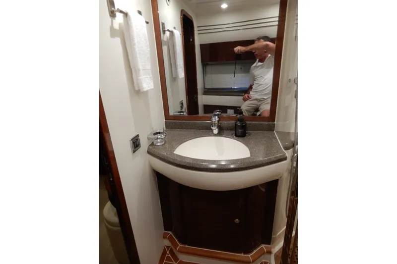 Slide: The Image of Bathroom interior of 2008 Viking Sport Cruisers 61 Motor Yacht with sink and mirror. - 117