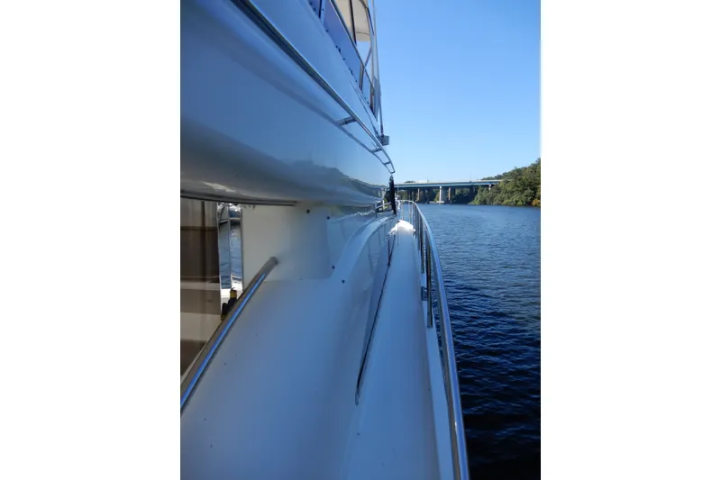 Slide: The Image of 2008 Viking Sport Cruisers 61 Motor Yacht on serene waterway, side view. - 14
