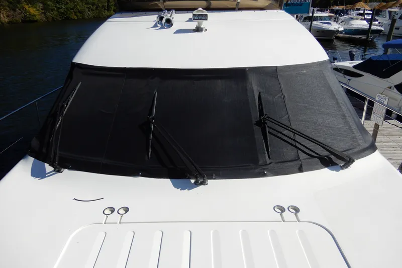 Slide: The Image of 2008 Viking Sport Cruisers 61 Motor Yacht with covered windshield at marina. - 21