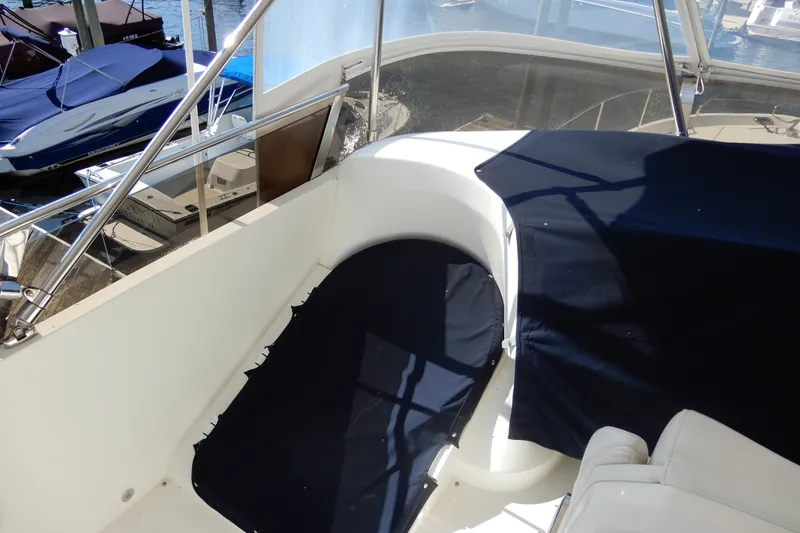 Slide: The Image of 2008 Viking Sport Cruisers 61 Motor Yacht deck with navy covers and marina view. - 40