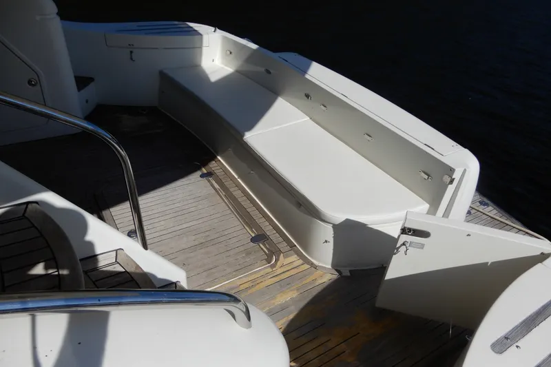 Slide: The Image of 2008 Viking Sport Cruisers 61 Motor Yacht deck with seating and open hatch. - 13