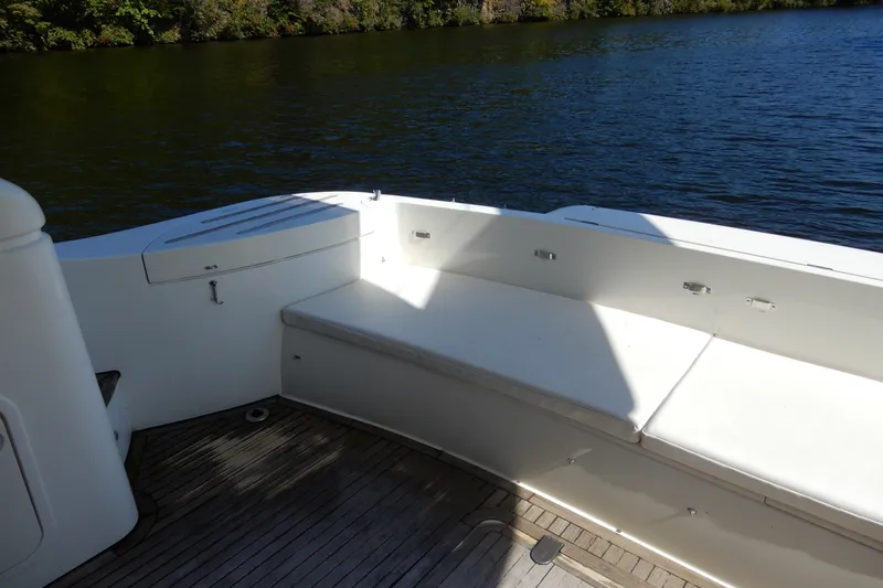 Slide: The Image of 2008 Viking Sport Cruisers 61 Motor Yacht deck with seating, overlooking serene water. - 10