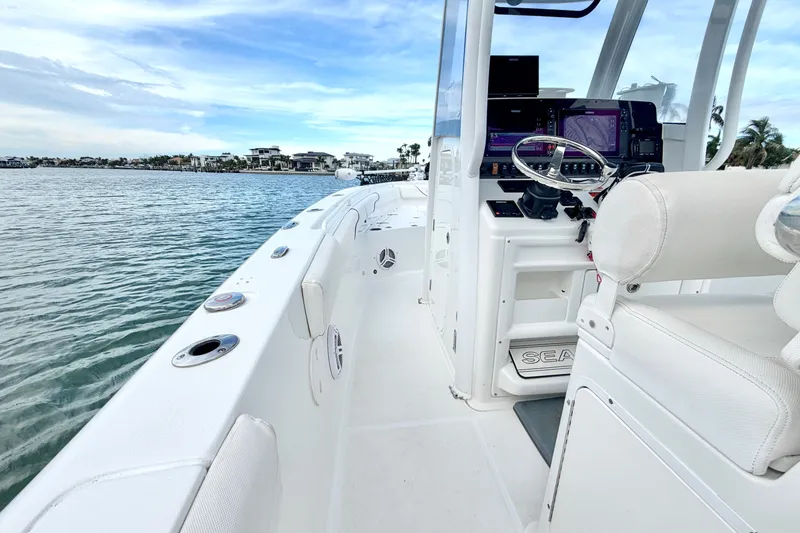 Slide: The Image of 2017 Sea Hunt Gamefish 27 boat interior with modern controls and ocean view. - 17