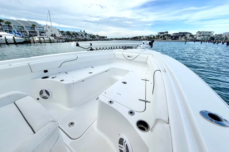Slide: The Image of 2017 Sea Hunt Gamefish 27 boat interior with spacious seating and scenic marina view. - 20