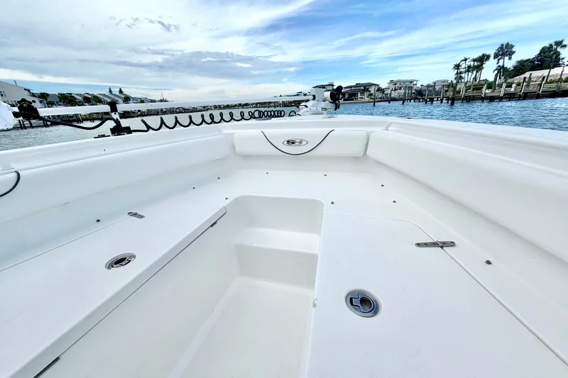 Slide: The Image of 2017 Sea Hunt Gamefish 27 boat interior with spacious seating and scenic waterfront view. - 22