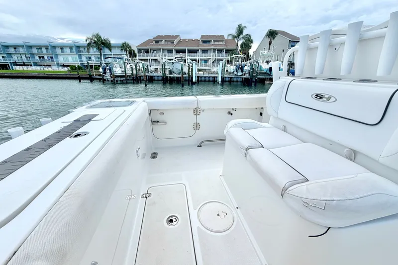Slide: The Image of 2017 Sea Hunt Gamefish 27 boat interior with waterfront view and docked boats. - 15