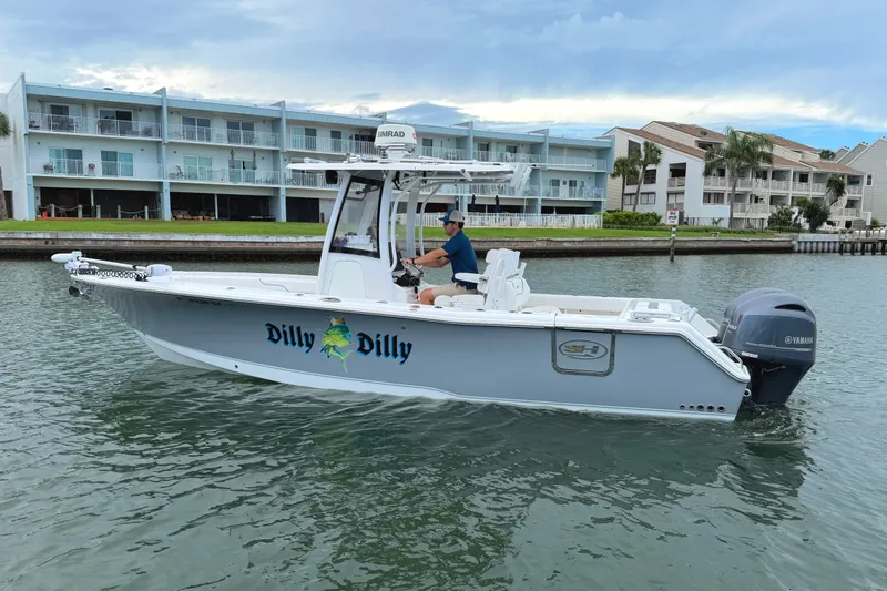 Slide: The Image of 2017 Sea Hunt Gamefish 27 boat on water, featuring "Dilly Dilly" graphics, near waterfront buildings. - 7