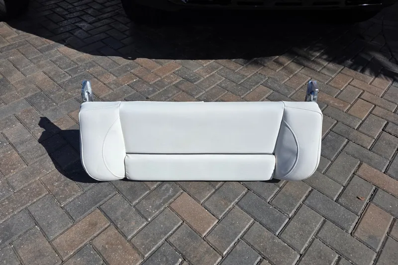 Slide: The Image of White boat seat from a 2017 Sea Hunt Gamefish 27 on brick pavement. - 27