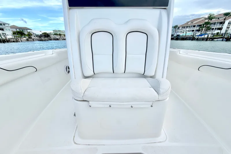 Slide: The Image of 2017 Sea Hunt Gamefish 27 boat interior with white seating, dockside view. - 25