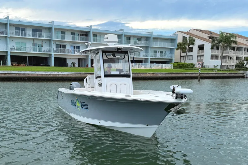 Slide: The Image of 2017 Sea Hunt Gamefish 27 boat on water near waterfront buildings. - 3