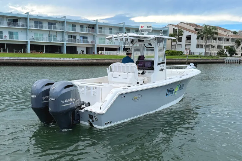 Slide: The Image of 2017 Sea Hunt Gamefish 27 boat with dual Yamaha engines on a calm waterway. - 8