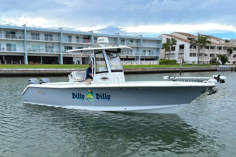 The Image of 2017 Sea Hunt Gamefish 27 boat named "Dilly Dilly" on water near waterfront buildings. - 0