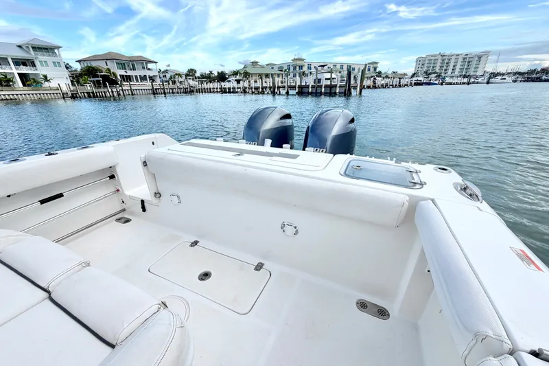 Slide: The Image of 2017 Sea Hunt Gamefish 27 boat with dual engines docked in a scenic marina. - 12