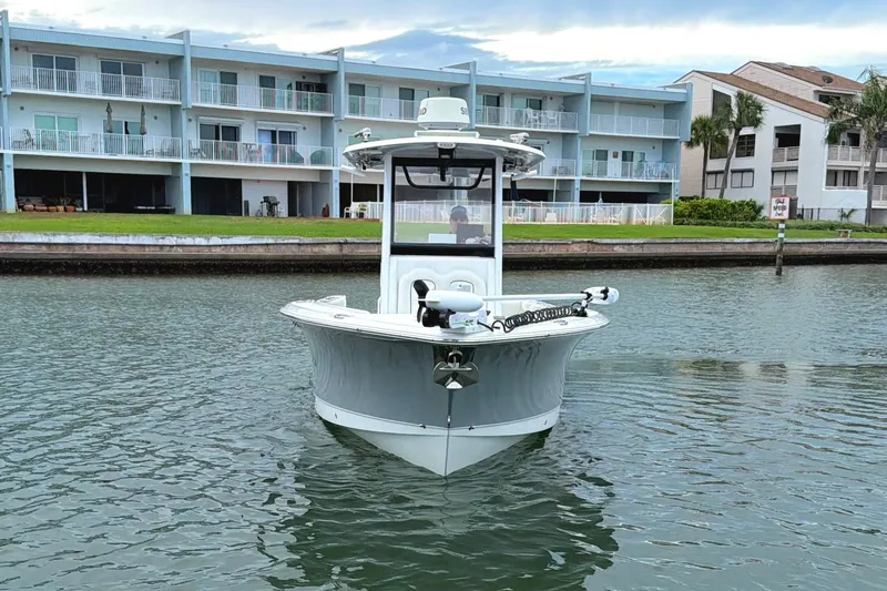 Slide: The Image of 2017 Sea Hunt Gamefish 27 boat on calm water near waterfront buildings. - 4