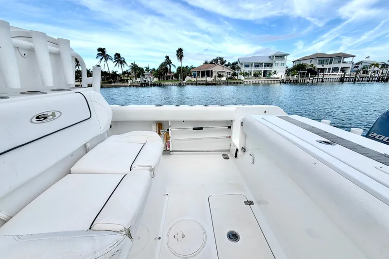 Slide: The Image of 2017 Sea Hunt Gamefish 27 boat interior with waterfront view and palm trees. - 13