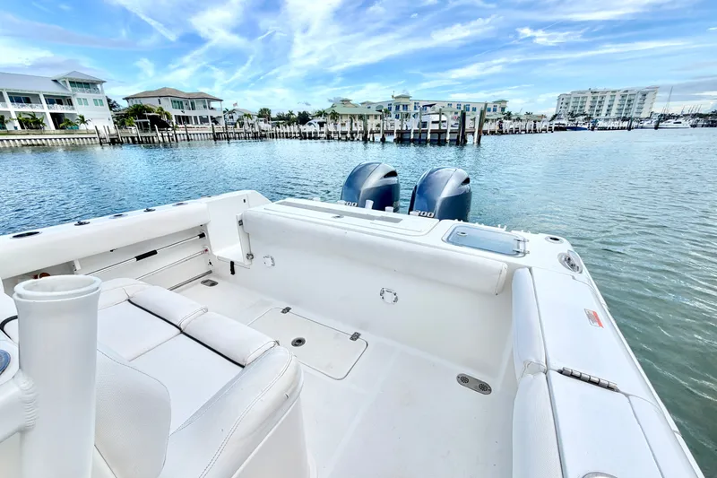 Slide: The Image of 2017 Sea Hunt Gamefish 27 boat with twin engines docked in a scenic marina. - 11