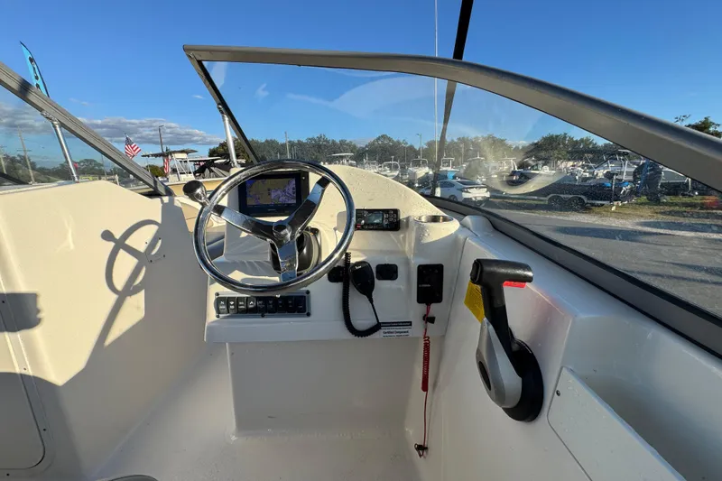 Slide: The Image of Cockpit of 2021 Key West 203 DFS boat with steering wheel and navigation system. - 21