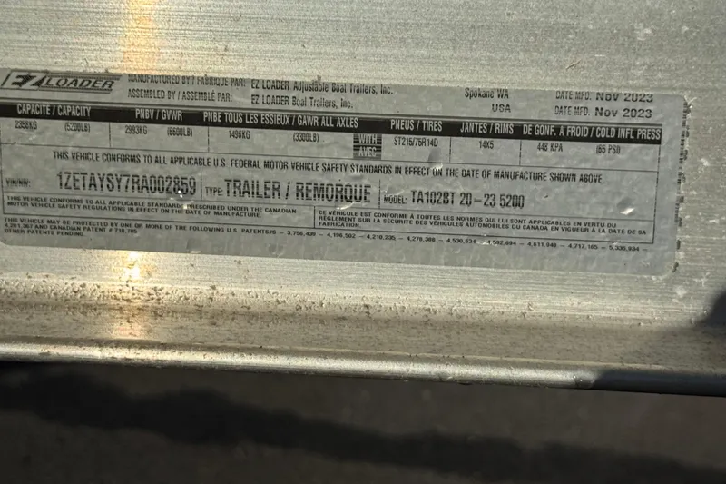 Slide: The Image of Label on EZ Loader trailer, model TA102BT, manufactured November 2023. - 59