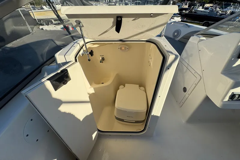 Slide: The Image of 2021 Key West 203 DFS boat interior with compact marine toilet. - 27