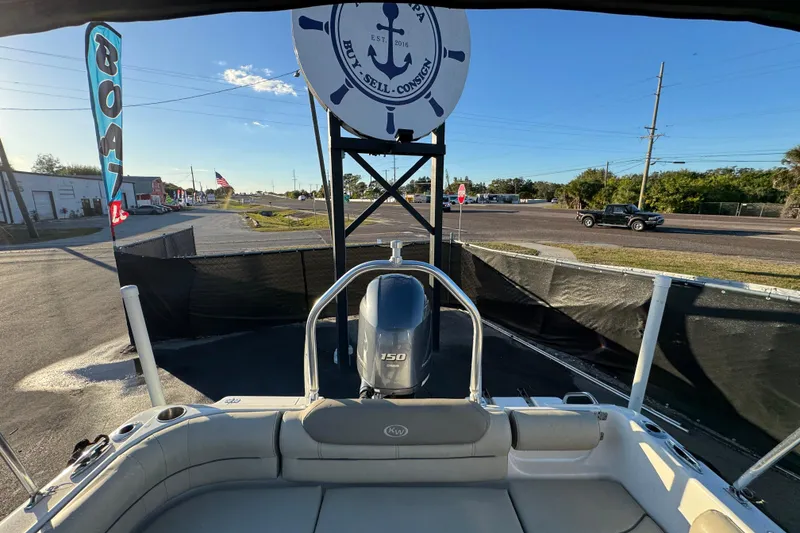 Slide: The Image of 2021 Key West 203 DFS boat displayed at dealership with signage and road view. - 49