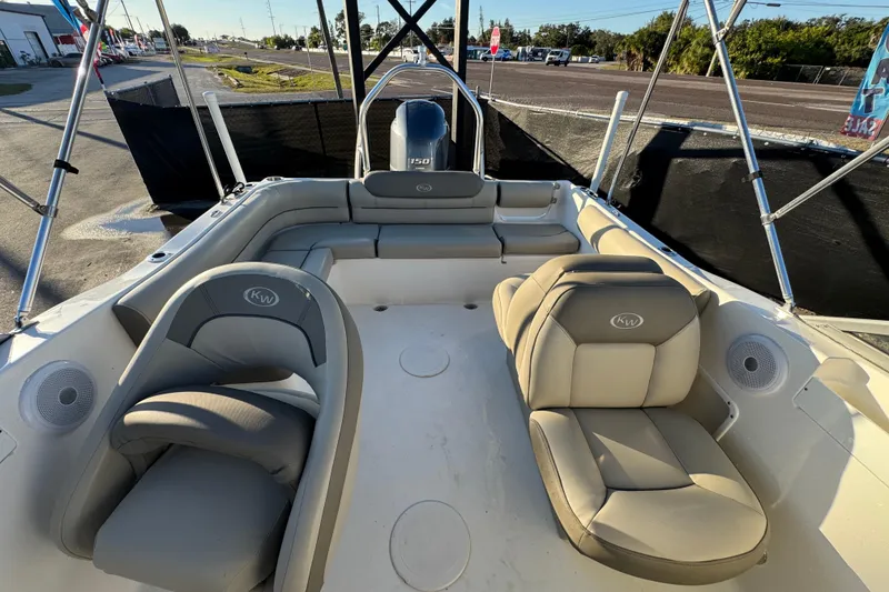 Slide: The Image of 2021 Key West 203 DFS boat interior with beige seating and steering console. - 45