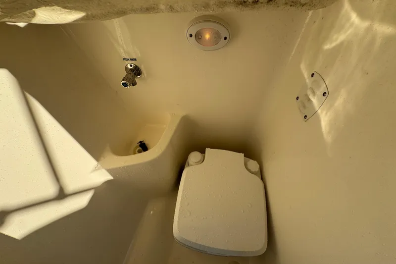 Slide: The Image of 2021 Key West 203 DFS boat interior with toilet and fresh water faucet. - 28