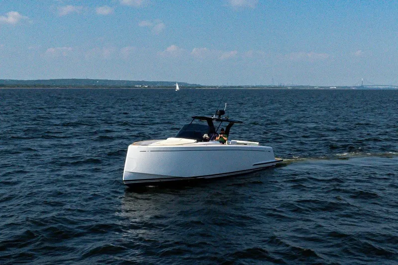Slide: The Image of A sleek, modern boat cruising on calm waters with a clear blue sky in the background. - 3