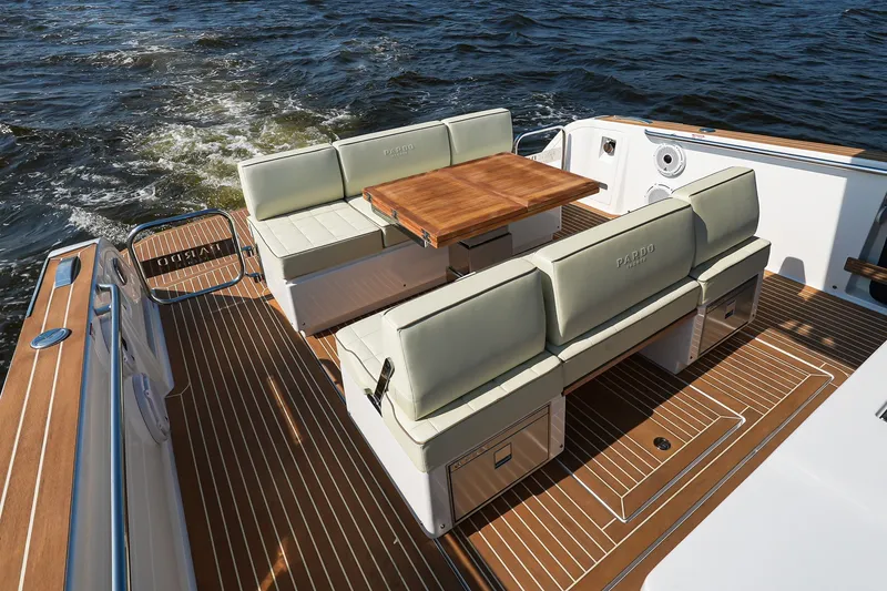 Slide: The Image of Luxurious 2025 Pardo Yachts P38 deck with elegant seating and wooden table on open water. - 13